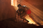 Wrestlers battle near a light beam.JPG